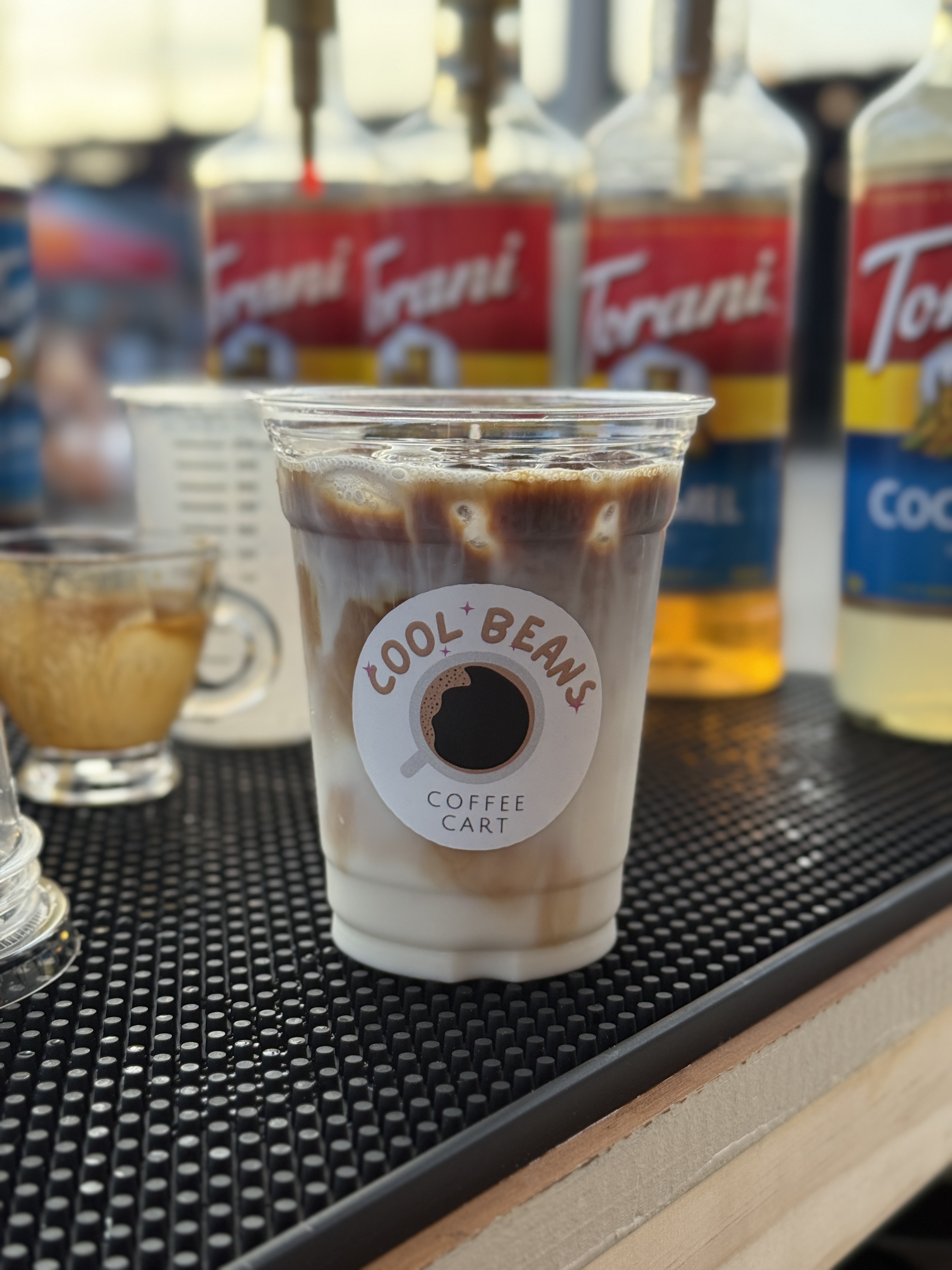 Iced latte on the bar with Torani syrups